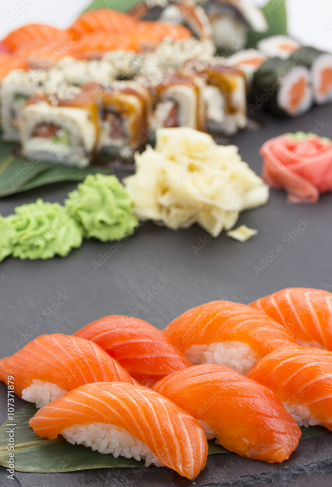 Japanese cuisine. Salmon sushi nigiri over black background Japanese cuisine. Salmon sushi nigiri over black background