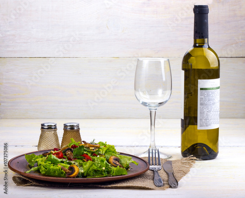White wine with vegetable salad of greens, mushrooms and tomatoes with seasoning
