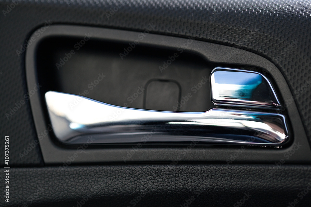 the handle in the car door, the interior detail inside the car