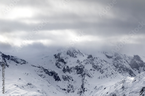 Snowy mountains in haze and storm clouds © BSANI
