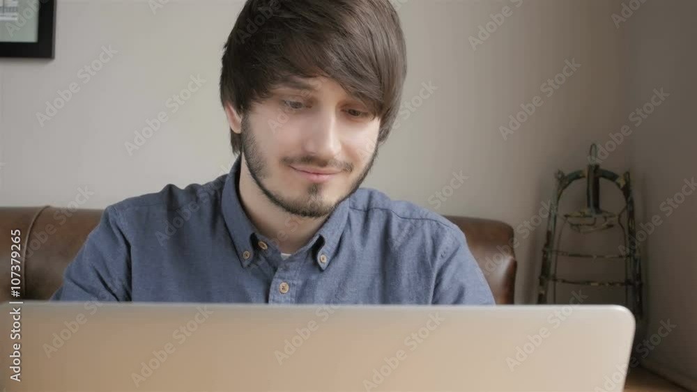 Happy Young Man Freelancer with Modern Laptop in Cafe taking Cup of Coffee Happy Young Man Freelancer with Modern Laptop in Cafe taking Cup of Coffee