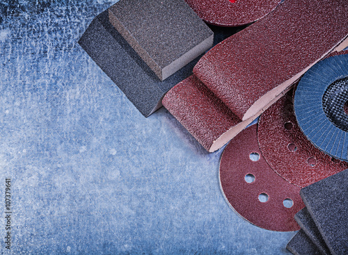 Set of abrasive tools on metallic background horizontal view