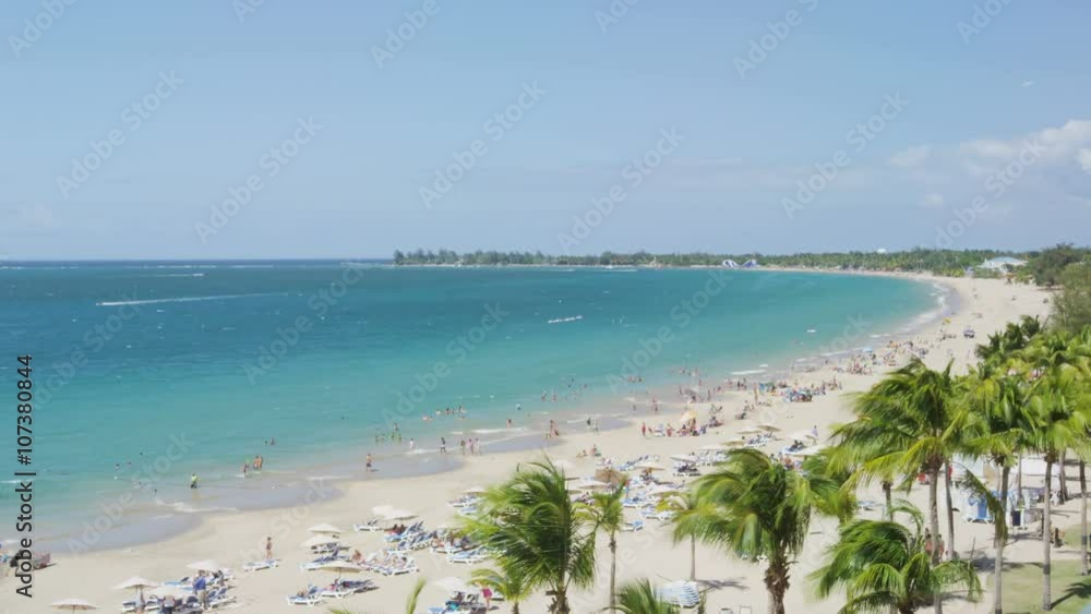 Isla Verde Beach in Puerto Rico. Tourist destination with beach resort and cruise ship tourists, Unrecognizable people enjoying beach summer holiday vacation on caribbean travel. Time lapse. Isla Verde Beach in Puerto Rico. Tourist destination with beach resort and cruise ship tourists, Unrecognizable people enjoying beach summer holiday vacation on caribbean travel. Time lapse.