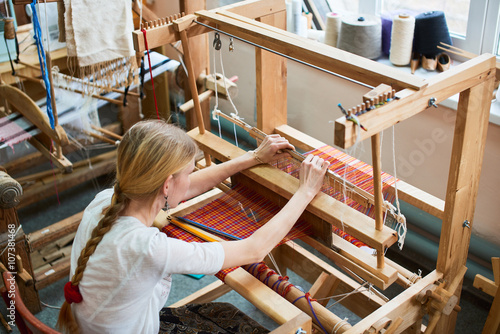 Tapeta The girl in the production process of textiles are handmade on a loom