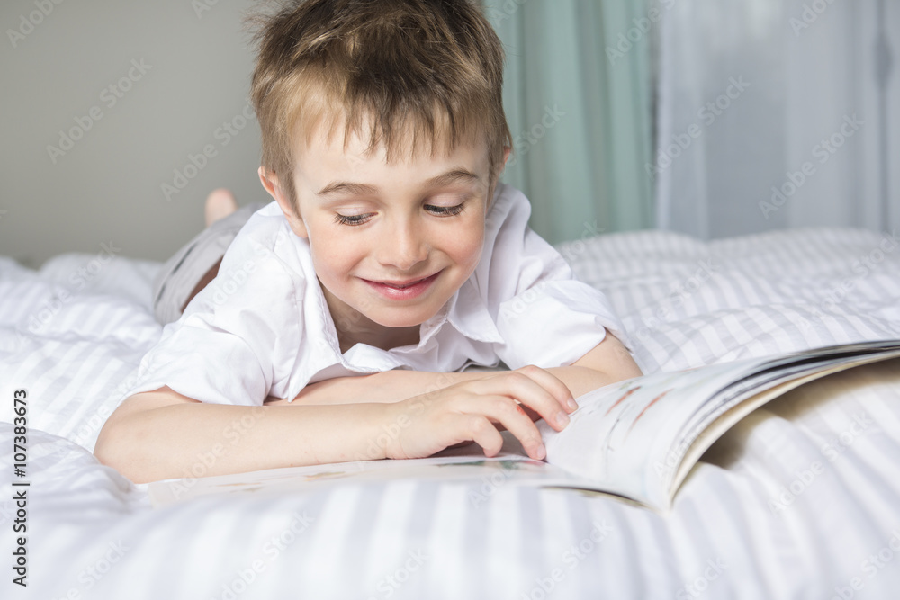little boy reading before dream in his bed little boy reading before dream in his bed