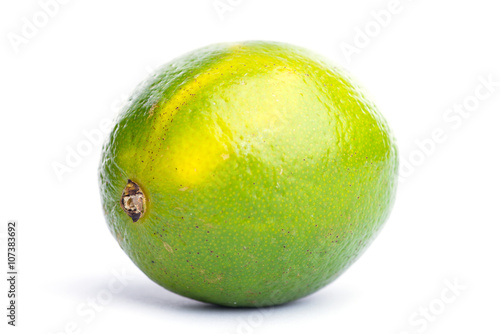 Whole fresh lime on on white  DOF