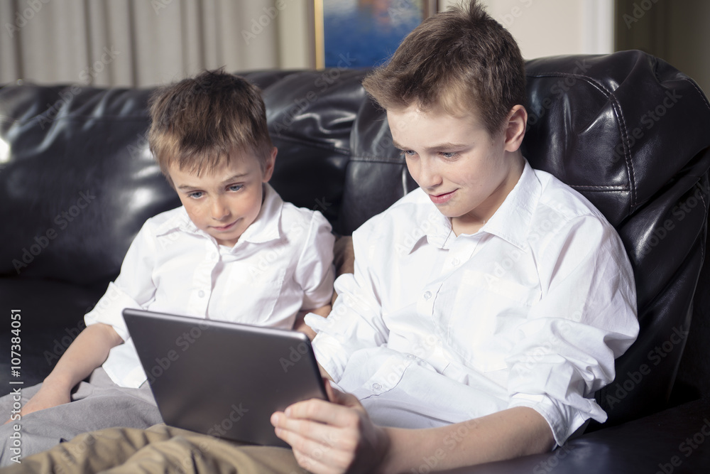 Children playing with tablet pc Children playing with tablet pc