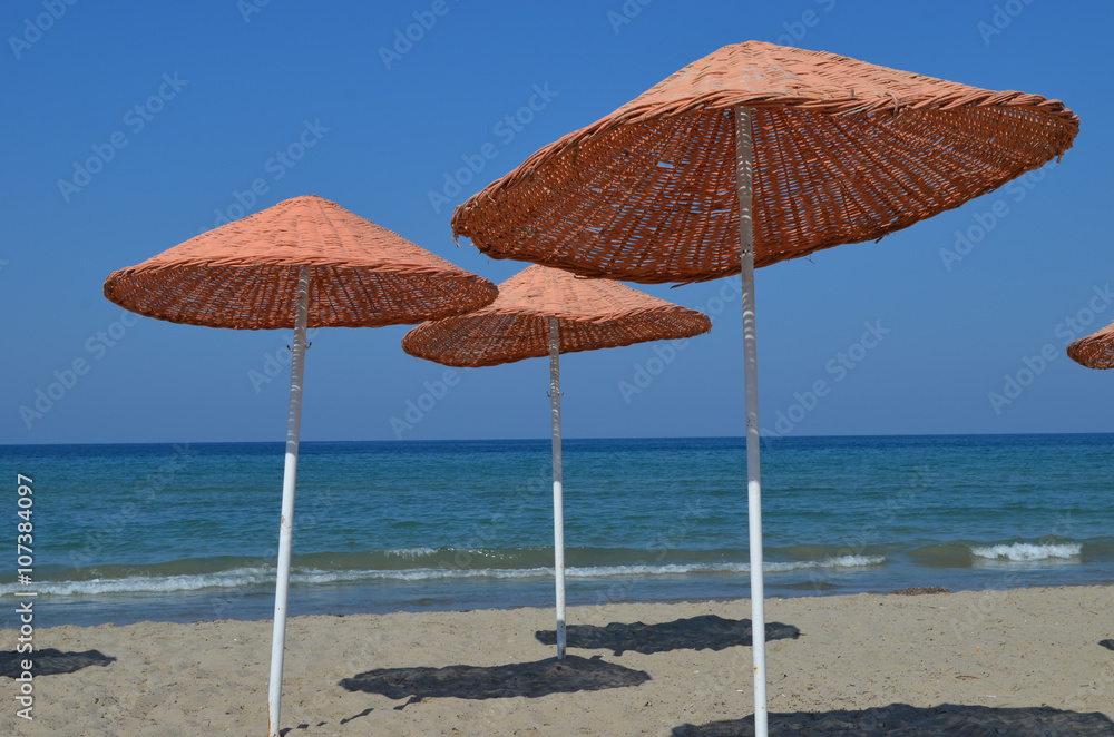 Colourful parasols on the beach at the Turkish Riviera close to Kusadasi