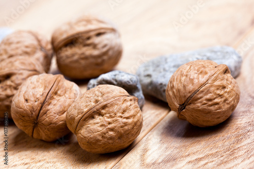 Walnuts on rustic wooden board © fotoru