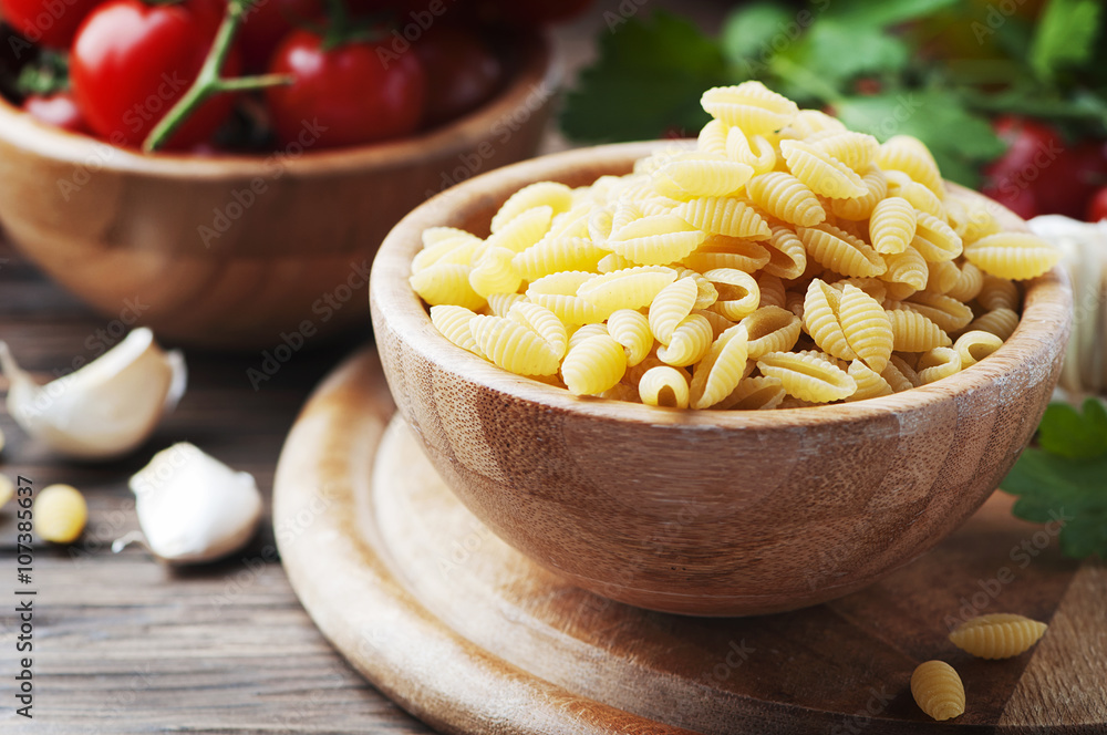 Sardinian uncooked pasta on the wooden table Sardinian uncooked pasta on the wooden table
