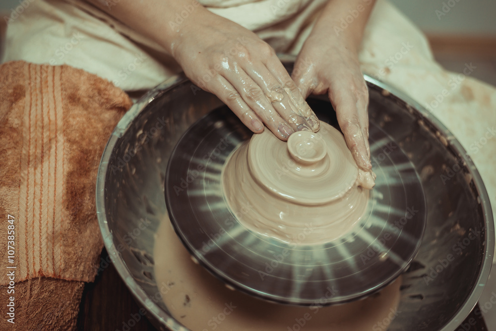 Fototapeta premium child working on potter's wheel