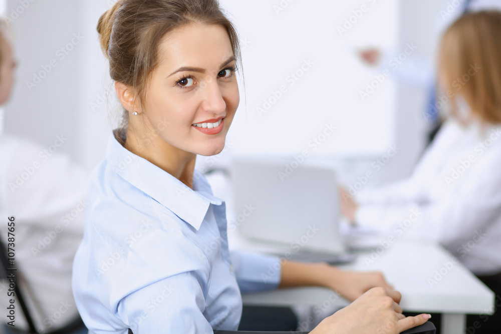 Beautiful business woman on the background of business people during meeting Beautiful business woman on the background of business people during meeting