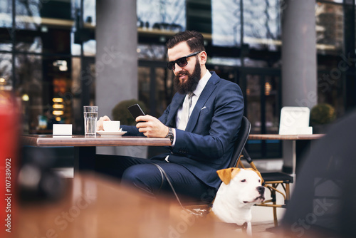 Businessman checking email and drinking coffee.