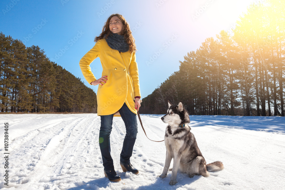 woman walks with dog in the winter forest woman walks with dog in the winter forest