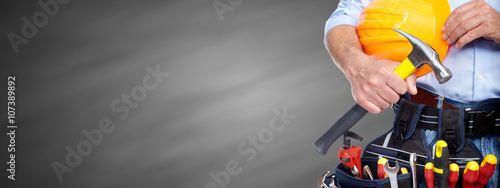 Builder handyman with construction tools. photo