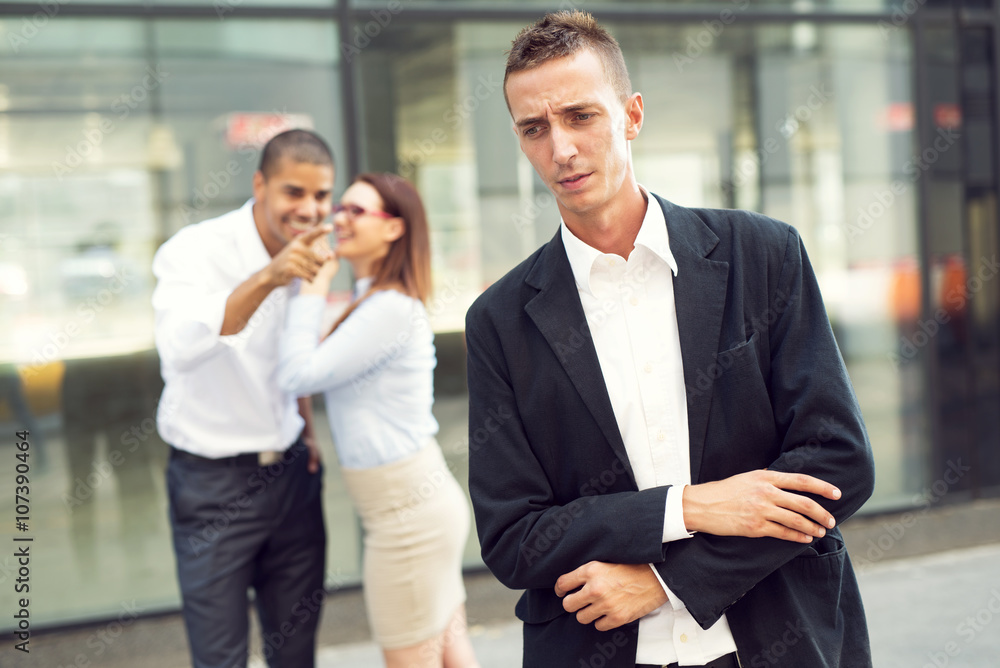 Gossip colleagues in front of their office, businessman portrait and gossiping out of focus in background. Gossip colleagues in front of their office, businessman portrait and gossiping out of focus in background.