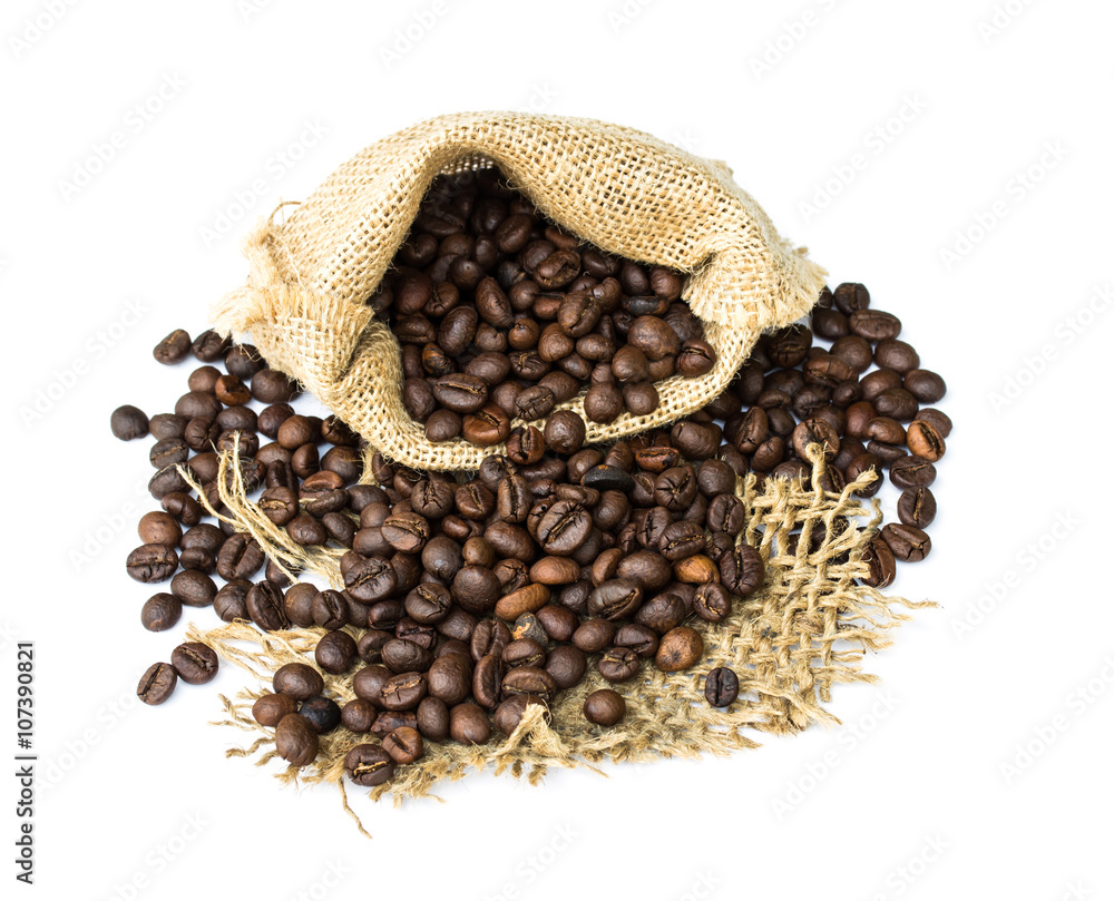 Fototapeta premium roasted coffee beans spilled on pile and in burlap sacks over wh