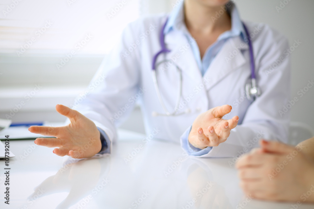 Doctor and patient are discussing something, just hands at the table Doctor and patient are discussing something, just hands at the table