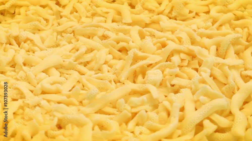 Grated Cheese Rotating On Plate Grated Cheese Rotating On Plate