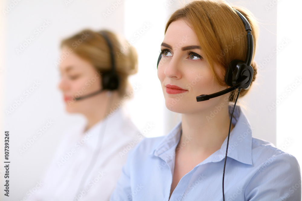 Call center. Focus on beautiful woman in headset Call center. Focus on beautiful woman in headset