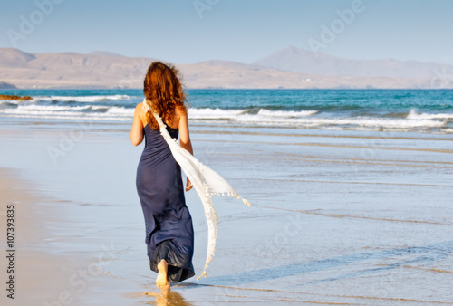 Young woman walking on the beach