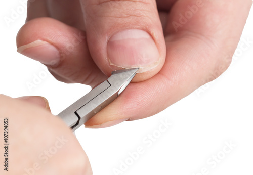 cutting the nails on her hand