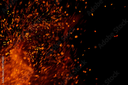Fototapeta fire flames with sparks on a black background