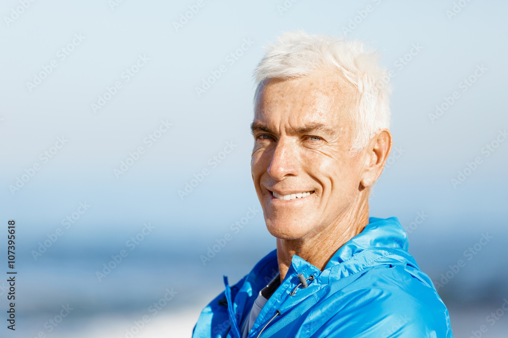 Man standing on beach in sports wear Man standing on beach in sports wear
