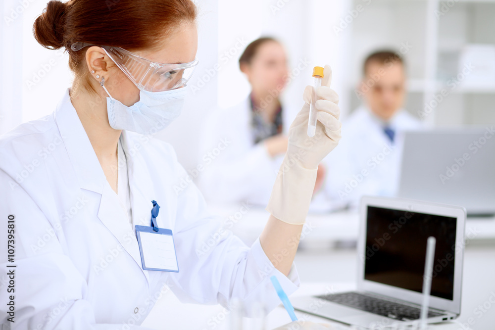 Scientific research team with clear solution in laboratory Scientific research team with clear solution in laboratory