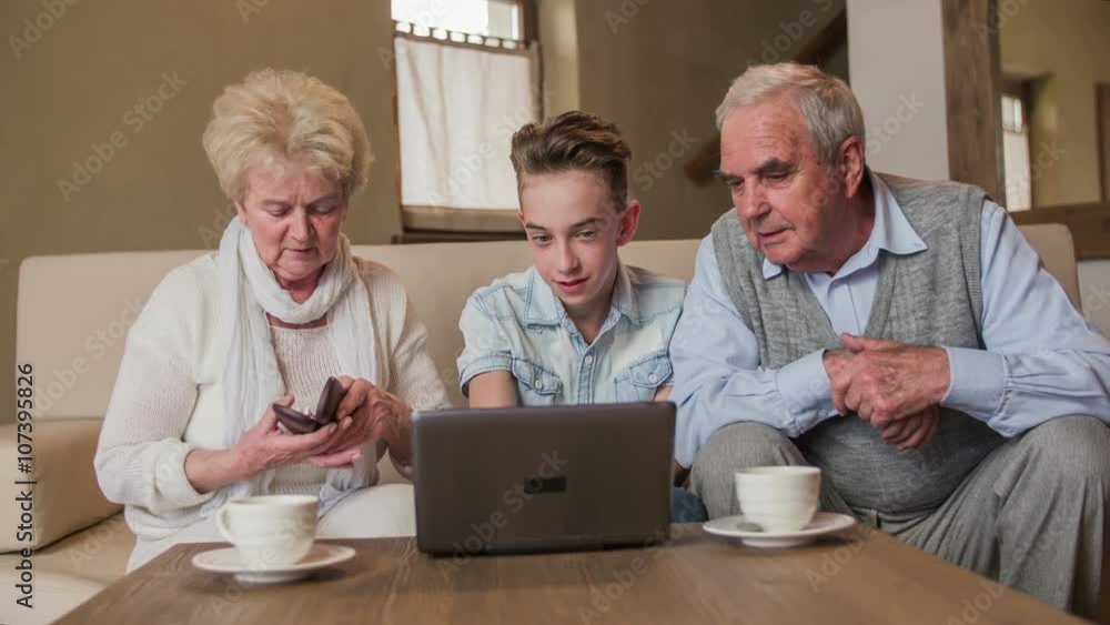 Grandparents looking on small laptop screen Grandparents looking on small laptop screen