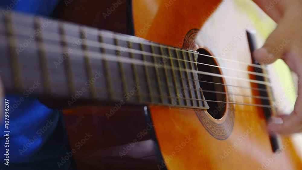 Sliding fingers over strings close up Sliding fingers over strings close up