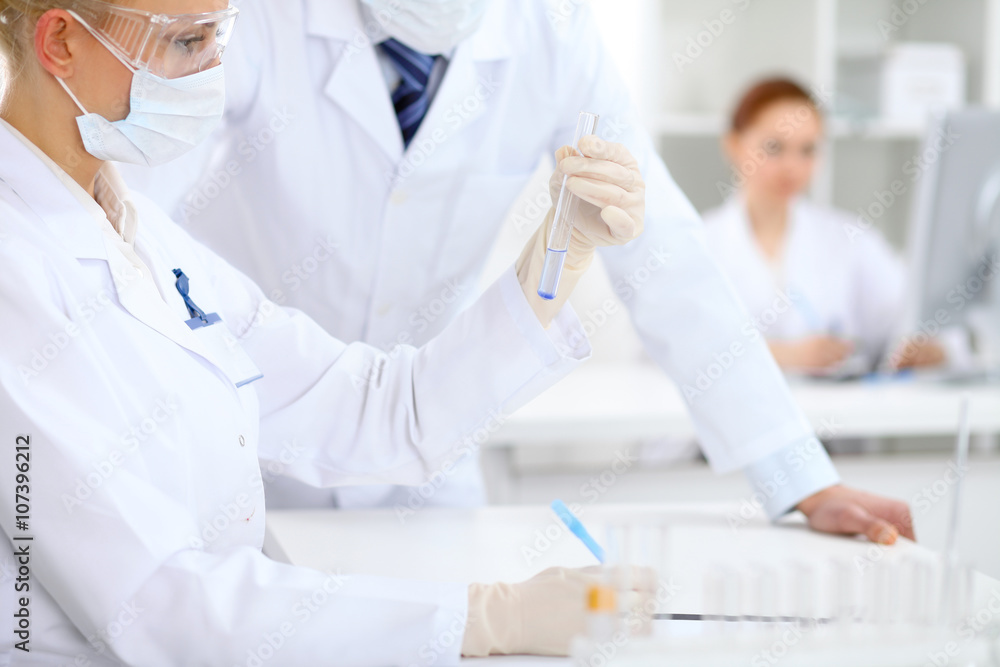 Scientific research team with clear solution in laboratory Scientific research team with clear solution in laboratory