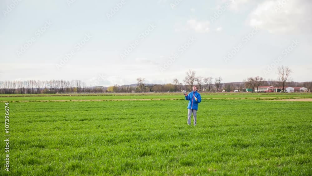 Boy holding strings of wind kite far in air Boy holding strings of wind kite far in air