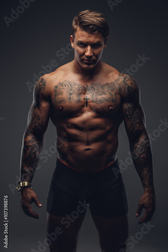 Naked muscular tattooed man