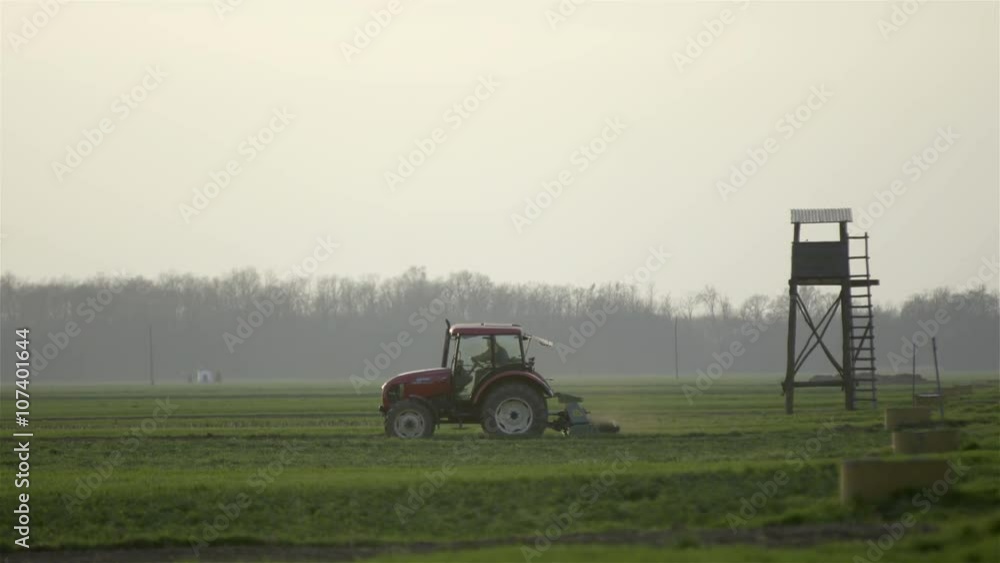 Tractor plowing side shot in the morning Tractor plowing side shot in the morning