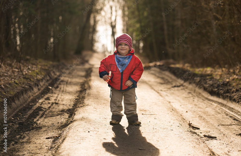 Fototapeta premium Happy caucasian boy playing outdoor in forest