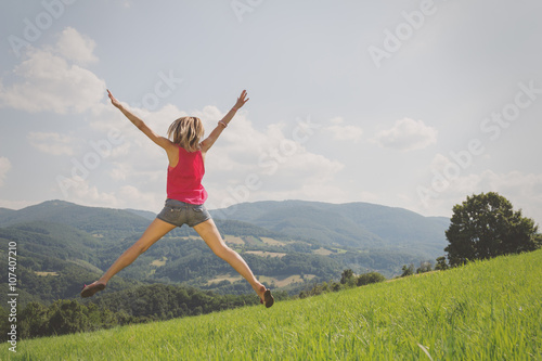 Girl jumping in a field.