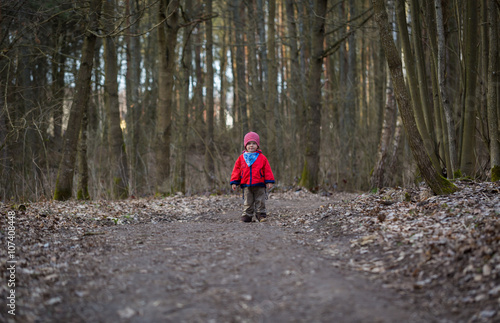 Happy caucasian boy playing outdoor in forest