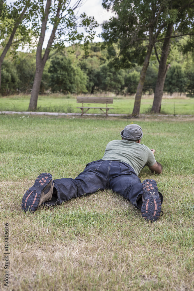 man laying on grass man laying on grass