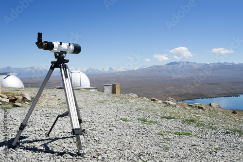telescope and observatory on ground near lake in summer day in n