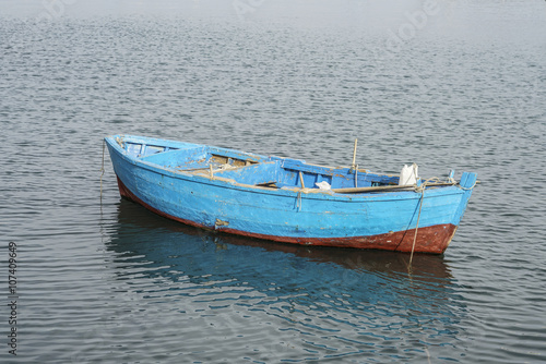 blue coloured wooden boat on sea