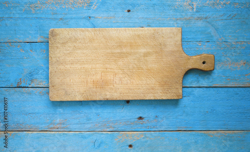 Empty old cutting board on planks, food background, copy space