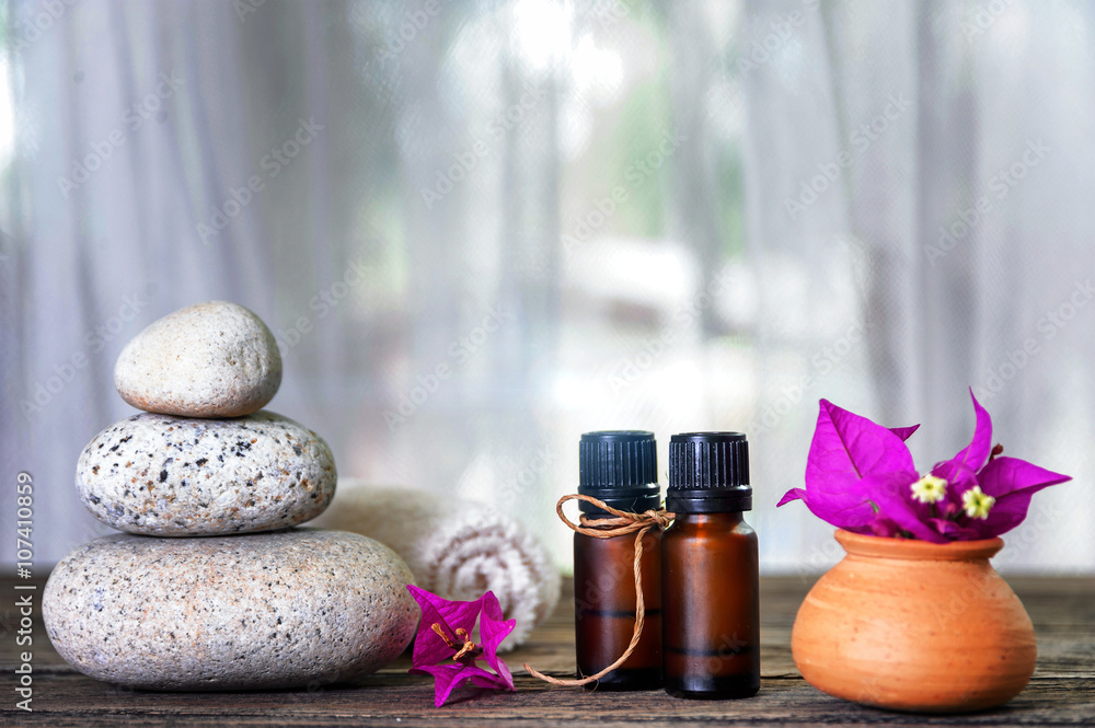 Spa still life with candle,zen stone and essential oil on wooden table Spa still life with candle,zen stone and essential oil on wooden table