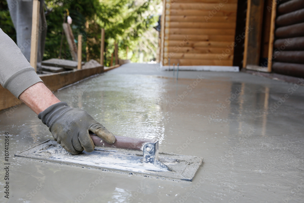 Mason leveling and screeding concrete floor base