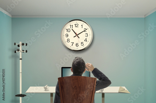 Relaxed businessman watching clocks
