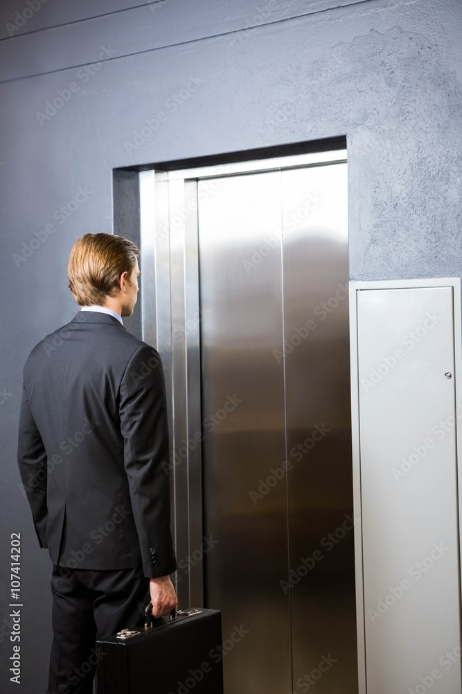 Businessman waiting for elevator Businessman waiting for elevator