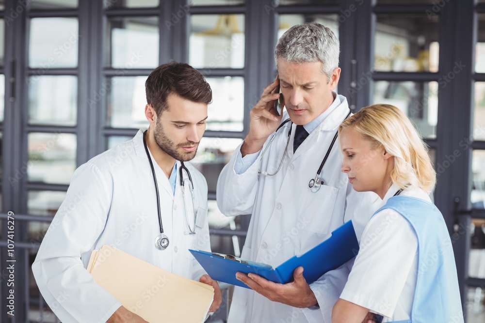 Senior doctor working with coworkers Senior doctor working with coworkers
