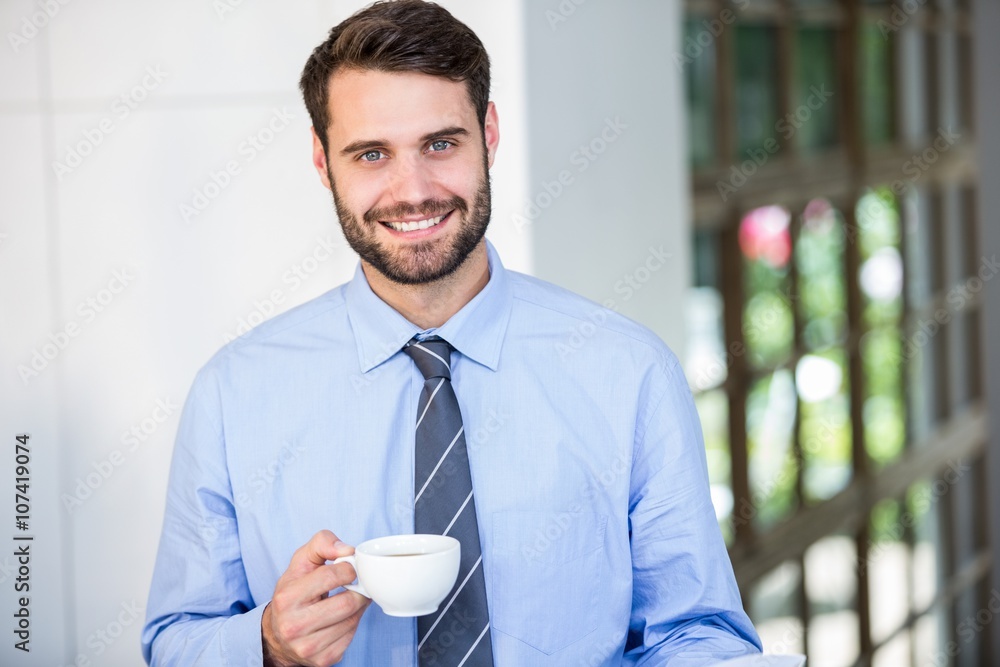 Confident businessman holding coffee cup Confident businessman holding coffee cup
