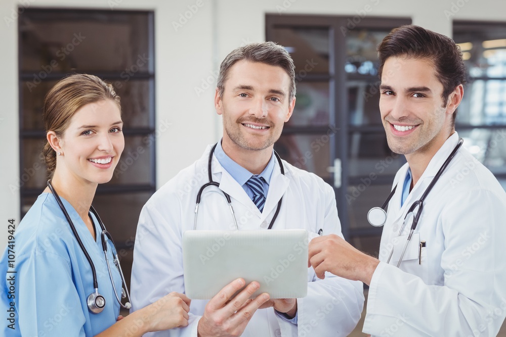 Portrait of smiling doctors holding digital tablet Portrait of smiling doctors holding digital tablet