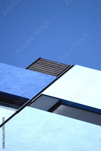 Abstract architecture background. Blue geometry against sky.
